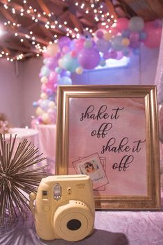 a camera sitting on top of a table next to a sign