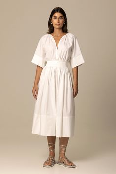 Made of Italian certified organic cotton fabric, the Ania dress in crisp white is inspired by the aesthetic of traditional Romanian peasant dresses. Featuring a relaxed top with gathered neckline and sleeves, a full skirt with concealed zipper closure, side seam pockets and elasticized waistband at the back, the result is a flattering and timeless silhouette. Beautifully crafted inside and out, the dress is perfect for long summer days and beyond. Fit: Bianca, our model is 5.8” or 1.77m tall and White Poplin Dress, Peasant Dresses, Russian Dress, Wash And Fold, Gathered Neckline, White Cotton Dress, Cotton Shirt Dress, Poplin Dress, Peasant Dress