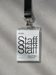 an identification badge attached to a lanyard on a concrete surface with the words 8 staff films production printed on it