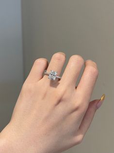 a woman's hand with a diamond ring on it