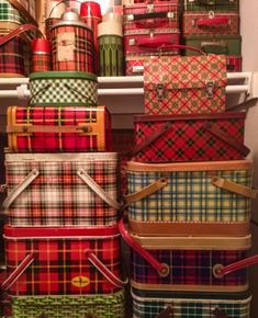 many plaid suitcases are stacked on top of each other in the closet, all lined up