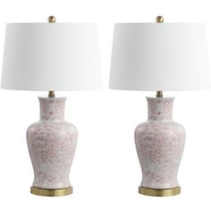 two pink and white vases with lamps on them