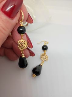 Beautiful handmade earrings with black agate beads and 18K gold plated metal components. For this creation I was inspired by the classic 50s style. I used the contrast of gold and black colors which makes the earrings very elegant. The earrings are long, very elegant and romantic thanks to the floral elements as connectors. Suitable for an elegant evening dress for an important party. They match with some long agate necklaces that I offer in my shop. All jewels are delivered in a decorated box, ready to be given as a gift to your loved one. How to take care of your jewellery: put on your beauty products (cosmetics, perfumes, ...) before wearing your precious jewel. Clean your jewelry with a soft cloth after wearing. Don't use water. Make sure you store your jewelry separately to avoid scra Black Gold-plated Pierced Earrings, Black Gold-plated Earrings, Black Gold-plated Earrings For Gift, Black Gold-plated Earrings For Formal Occasions, Elegant Onyx Earrings, Formal Black Gold-plated Earrings, Elegant Gold Earrings With Black Enamel, Elegant Onyx Earrings For Party, Onyx Earrings For Evening