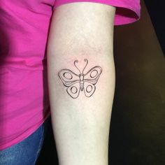 a woman with a butterfly tattoo on her left arm and the word love is written in cursive writing