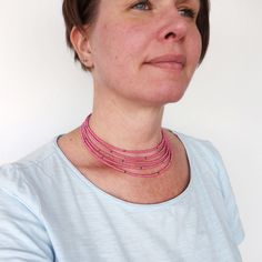 Beaded layered choker necklace multi stranded pink grey seed beads. Choker beaded with small glass beads in five strands, mostly pink seed beads with just a few grey ones spread out on the strands. All strands are of slightly different length, making the layers around the neck. Elegant beaded necklace for women in a minimalist style. Glass beads are about 2,5 mm. The necklace closes with a lobster clasp in a chain. Length (of shortest strand) is about 14 1/2 inches (37 cm), plus a lengthening chain of about 2 inches or 5 cm. This necklace is beaded only by hand. Only one necklace available in this color! For more layered choker necklaces please visit: https://etsy.me/2J1zRMC Or visit my shop: https://www.etsy.com/se-en/shop/tline/ Care information: Always remove jewelry before exercising, Pink Beaded Choker With Round Beads, Pink Choker With Round Tiny Beads, Pink Tiny Beads Choker Necklace, Pink Multi-strand Faceted Bead Necklace, Pink Multi-strand Beaded Necklace With Faceted Beads, Pink Multi-strand Faceted Beaded Necklace, Pink Multi-strand Beaded Necklace, Elegant Beaded Necklace, Beads Choker