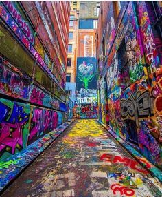 an alley with graffiti all over the walls