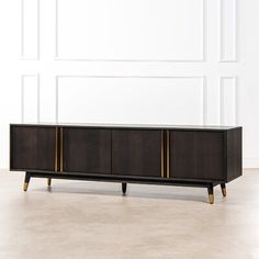 the sideboard is made out of wood and has gold trimmings