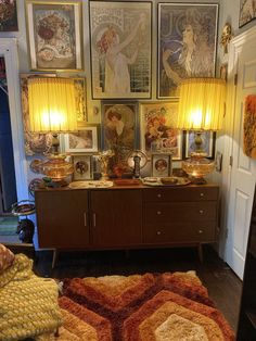 a living room filled with furniture and pictures on the wall