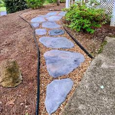 a stone path in the middle of a garden