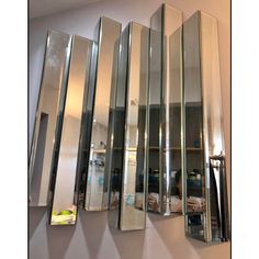 four mirrored mirrors are hanging on the wall