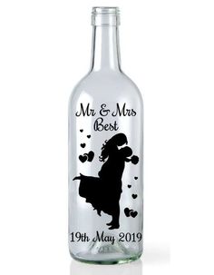 a personalized glass bottle with a silhouette of a dog and hearts on the label