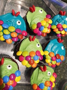 cupcakes decorated to look like fish with colorful candies