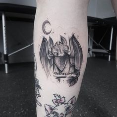 a person with a bat tattoo on their leg