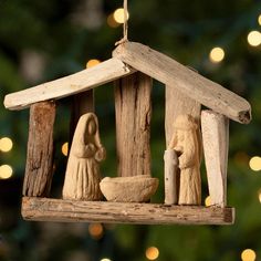 a nativity ornament hanging from a christmas tree