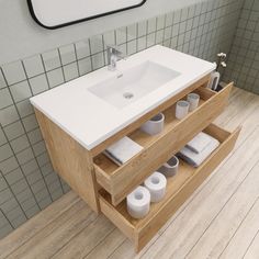 a bathroom with a sink, mirror and toilet paper