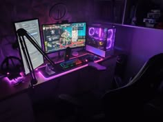 a computer desk topped with two monitors and a gaming mouse next to a keyboard on top of a chair