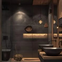 a bathroom with two sinks and lights on the wall above it, along with a wooden countertop