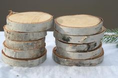 several pieces of wood are stacked on top of each other in front of a pine tree