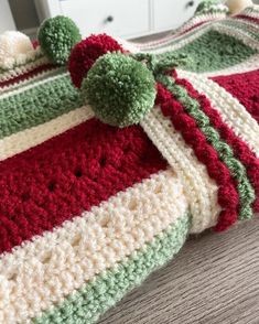 a crocheted bag sitting on top of a wooden table next to a white dresser