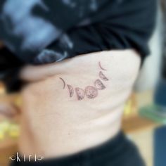 a woman with a tattoo on her stomach that says bood in cursive writing