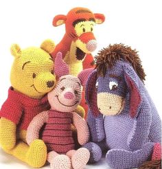 winnie the pooh and friends crocheted stuffed animals are posed next to each other