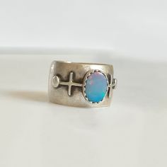 one-of-a-kind! sterling silver & australian opal i highly recommend sizing up a half to full size with this ring. wide ring bands will feel tighter than a more traditional ring band. ring size: us 6.75 (fits best on us size 5.75-6.25) please make sure you measure your ring size as i cannot resize this ring. handmade be me, in my austin, tx studio. you may see small marks & imperfections. or as i like to call them, wabi-sabi marks. Traditional Ring, Ring Bands, Geometric Symbols, Wide Ring, Wide Rings, Wide Band Rings, Original Bags, Purple Hues, Australian Opal