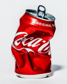 a can of coca - cola on a white background