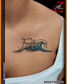 a woman with a tattoo on her chest that says fearless in the middle of it