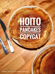 two pancakes sitting on top of a white plate next to a knife and fork