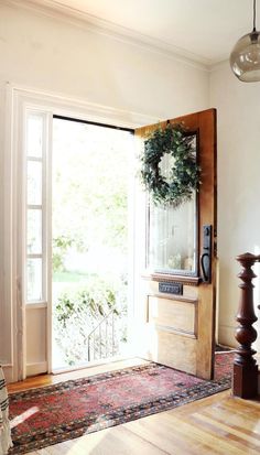 an open door with a wreath on it