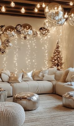 a living room filled with lots of white couches and christmas lights hanging from the ceiling