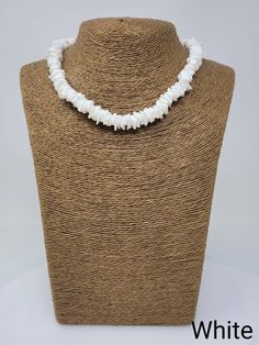 "Black and White Puka shell Necklace. Handmade with white seashell and black wooden beads 17\" Inches Around the neck Handmade Design. Necklace is Unisex Fits Most Sizes FAST SHIPPING! *First Class Mail* Visit my Etsy Shop to see more Designs! Handmade Earrings, Puka Shell Bracelets and Puka Shell Necklaces. Click here to see more designs: https://www.etsy.com/shop/FreedomLifeStyle" White Strand Pearl Necklace For Vacation, Vacation White Strand Pearl Necklace, White Strand Shell Necklace As Gift, White Strand Shell Necklace Gift, White Shell Strand Necklace For Gift, Bohemian White Shell-shaped Pearl Necklace, White Shell-shaped Beaded Necklace For Vacation, White Shell Beaded Necklaces, Adjustable White Pearl Necklace With Natural Stones