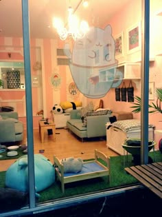 a living room filled with furniture and lots of windows covered in fake grass on top of a hard wood floor