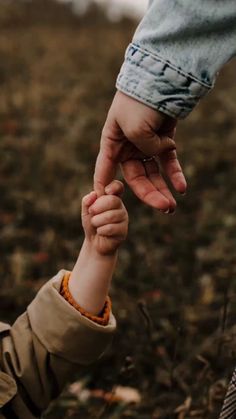 a person holding the hand of a child