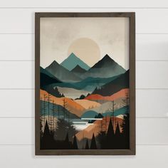 a painting hanging on the wall next to a wooden frame with trees and mountains in it