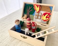 an open wooden box with toys in it