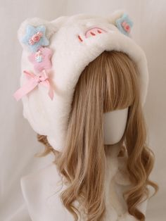 the wig is wearing a white hat with pink bows and blue flowers on it's ears