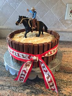 a cake decorated with a cowboy riding a horse