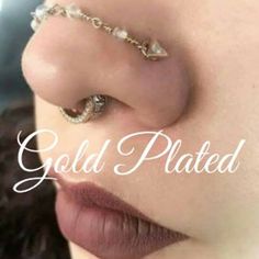 a woman with gold plated nose piercings on her nose and the words gold plated