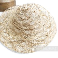 Vintage straw capelines are a treasure to behold - mainly because many of them were so labor intensive to make that they quite simply will never be made again. This is one of those!Made from natural undyed open weave stripe straw and twisted jute braid, this capeline dates back to at the least the 1960s and has a nice big brim so you can make the summer hat of all summer hats! They all have their own personality, some are more closely woven, some have more colour variation. A true sign that each Artisan Woven Straw Hat For Spring, Traditional Woven Straw Hat For Spring, Artisan Wide Brim Straw Hat In Natural Color, Artisan Straw Hat With Curved Brim In Natural Color, Natural Straw Woven Hat, Artisan Natural Straw Hat For Summer, Natural Artisan Straw Hat For Summer, Natural Wide Brim Straw Hat With Open Weave, Artisan Beige Straw Hat For Beach