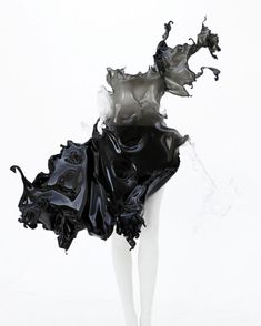 a mannequin is dressed in black and white with an unusual dress on it