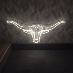 the longhorn logo is lit up on the wall