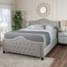 a bedroom with a bed, dresser and mirror in it's centerpieces