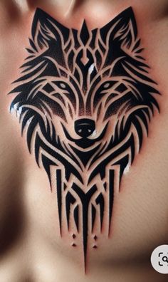 a black and white tattoo on the chest of a man with a wolf head in it