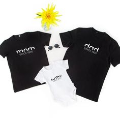 Celebrate family with this personalized matching shirt set featuring custom birth years for mom, dad, and baby. Perfect for birthdays, Mother's Day, Father's Day, and special family occasions.Introducing the Custom Birth Year Family Matching Shirt Set - a heartwarming and stylish gift that celebrates the unique bond between parents and their little one. This set includes three pieces: a 'mom' shirt, a 'dad' shirt, and a 'baby' bodysuit, each personalized with the respective birth years, creating Family Tee Shirts Ideas, Mom Dad And Baby, Mom Dad Baby, Dad And Baby, Father And Baby, Papa Shirts, Dad Shirts, Personalized Matches, First Fathers Day Gifts