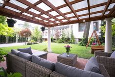 an outdoor living area with couches and tables