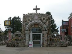 the entrance to an old church is decorated with flowers and crosses on it's sides