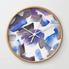 a clock with blue and purple paint splattered on it