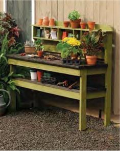 an outdoor bench with potted plants on it