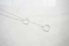 "Double Circle Karma Y Necklace This necklace is a perfect accessory to any outfit! This beautiful necklace is great to wear everyday. This is a great gift for a teenager, sister or your best friends birthday. This necklace is perfect to dress up, or perfect with a t-shirt and jeans. -Details This necklace does not come with a clasp, the smaller ring will go into the larger ring Length for necklace - 14 - 40\" this includes the length of the circles Circles one small and one larger - approx 10mm Adjustable Round Lariat Necklace In Dainty Style, Adjustable Sterling Silver Lariat Necklace As Gift, Adjustable Length Sterling Silver Lariat Necklace As Gift, Sterling Silver Lariat Necklace Gift, Gift Adjustable Sterling Silver Lariat Necklace, Handmade Minimalist Lariat Necklace As Gift, Minimalist Handmade Lariat Necklace For Gifts, Minimalist Handmade Lariat Necklace As Gift, Minimalist Round Lariat Necklace As Gift